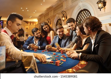 A group of people playing gambling in a casino