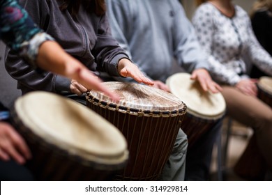 Group of people playing on drums - therapy by music - Shutterstock ID 314929814