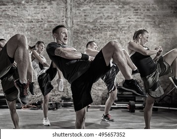group of people practicing kick, workout class