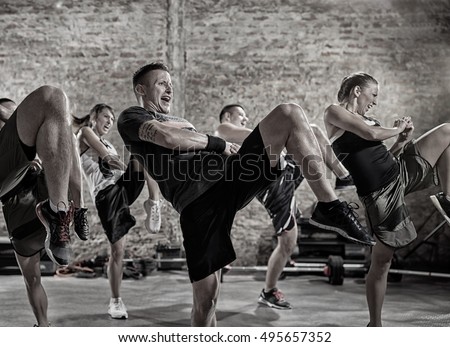
group of people practicing kick, workout class