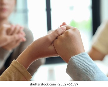 group of people praying together while holding hand on holy bible book at church. Concept of hope, religion, faith, christianity and god blessing. - Powered by Shutterstock