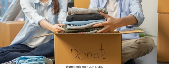 Group of people preparing clothes in donation box preparing to give to another people - Powered by Shutterstock