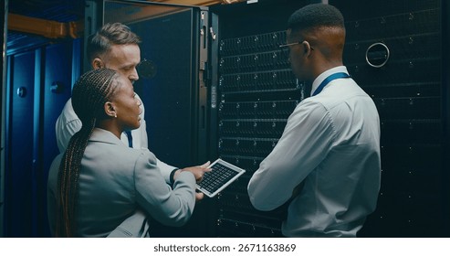 Group, people and programming with tablet in server room for security, software update and maintenance. Staff, team and screen for database upgrade, IT inspection and system backup of hardware repair