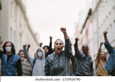 Group of people protesting and giving slogans in a rally. Group of demonstrators protesting in the city. - Shutterstock ID 1719924790