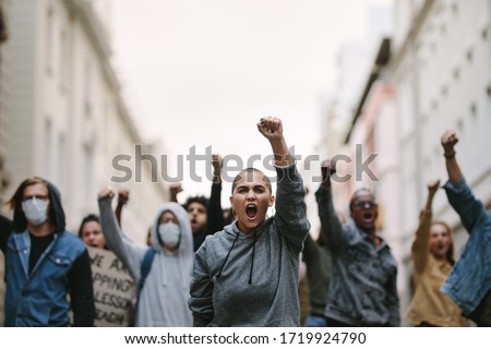 Group of people protesting and giving slogans in a rally. Group of demonstrators protesting in the city.