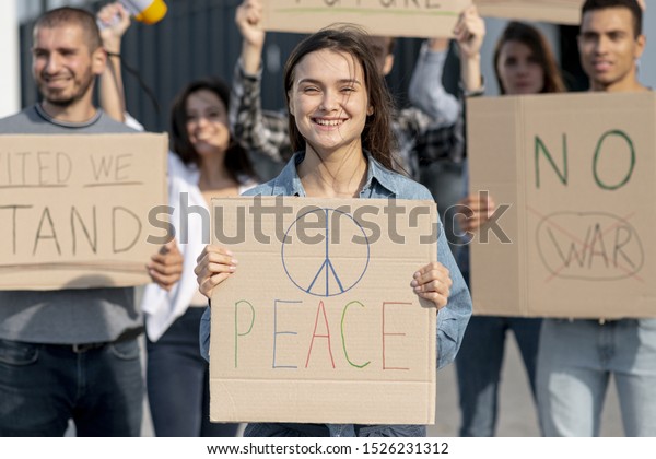 Group of people protesting\
for peace