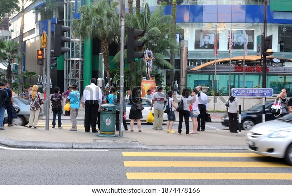 A group\
of people queues at a traffic light crossing in Bukit Bintang,\
Kuala Lumpur, Malaysia on April 21,\
2010