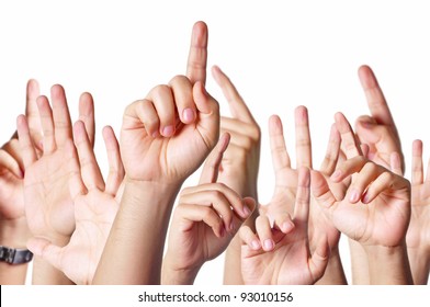 Group Of People Raising Hands To Answer A Question