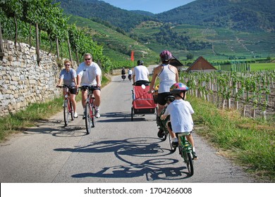 Group Of People Riding Bicycles Along The Danube River On The Famous Cycling Route Donauradweg. Lower Austria, Europe - August, 2016