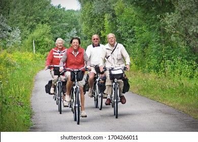 Group Of People Riding Bicycles Along The Danube River On The Famous Cycling Route Donauradweg. Lower Austria, Europe - August, 2016