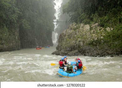 Group Of People River Rafting On Rio Pacuare In Costa Rica In The Pouring Rain