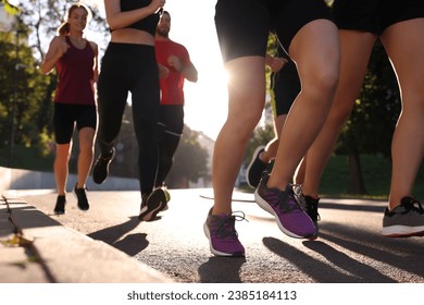 Group of people running outdoors on sunny day, closeup view - Powered by Shutterstock