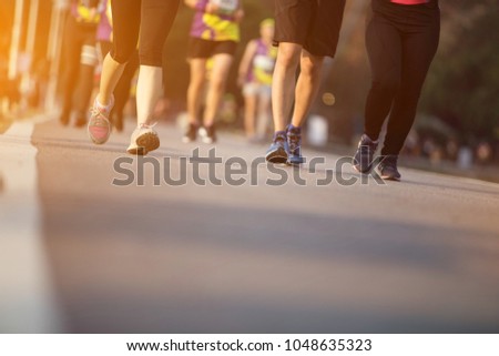 Group of people running race marathon.