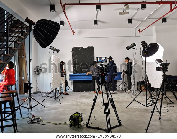 A group of people setting\
up the video shooting in the studio in Selangor, Malaysia - March\
2020