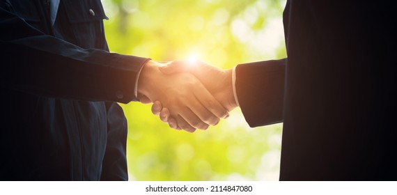 Group of people shaking hand inftont of green background. Teamwork of business. - Shutterstock ID 2114847080