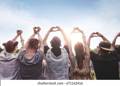 Group of people showing the heart shape  - Shutterstock ID 671162416