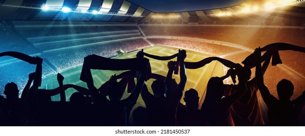 Group of people silhouettes. Back view of football, soccer fans cheering their team with and scarfs at crowded stadium at evening time. Concept of sport, cup, world, team, event, competition - Shutterstock ID 2181450537