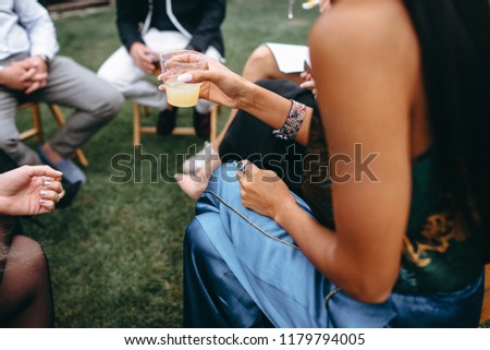 Similar – Woman holding lemonade glass and friends cooking in barbecue