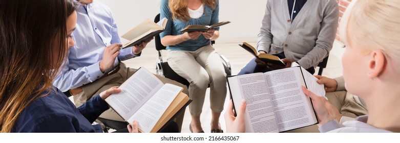 Group Of People Sitting On Chair In Circle Reading Bibles