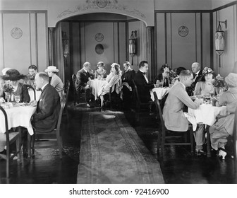 Group of people sitting in a restaurant having dinner