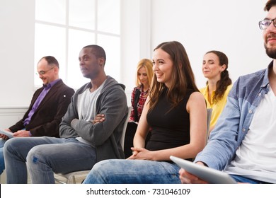 Group Of People Sitting At Seminar, Copy Space. Interested And Laughing Audience Listening To Speaker. Education, Conference, Workshop Concept