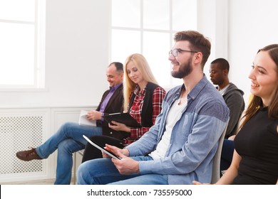 Group Of People Sitting At Seminar, Copy Space. Interested And Laughing Audience Listening To Speaker. Education, Conference, Workshop Concept