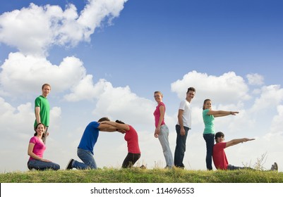 Group of people spelling word LOVE outdoors in nature - Shutterstock ID 114696553