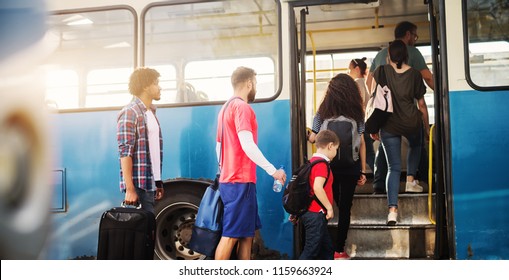 Group Of People Is Standing In Line And Waiting To Get In A Bus.