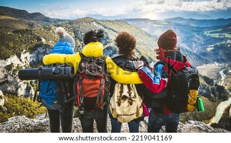 Group of people standing on the top of the mountain - Happy friends with backpacks having trekking weekend together - Sport, travel and hike concept