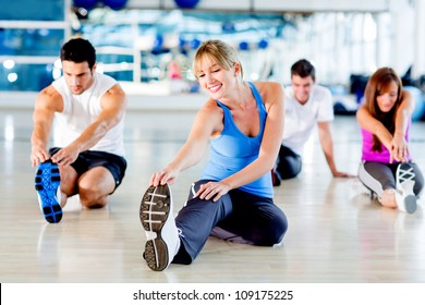 Group of people stretching at the gym - Powered by Shutterstock