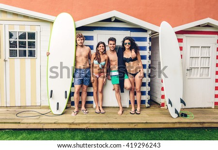 Similar – Young friends holding woman on top of surfboard