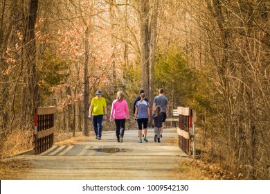 Group Of People Taking A Walk In The Park On A Nice Early Spring Day; Missouri, Midwest