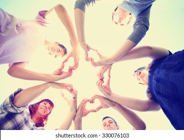 A Group Of People With Their Hands In A Circle Making Heart Shapes Toned With A Retro Vintage Instagram Filter App Or Action Effect