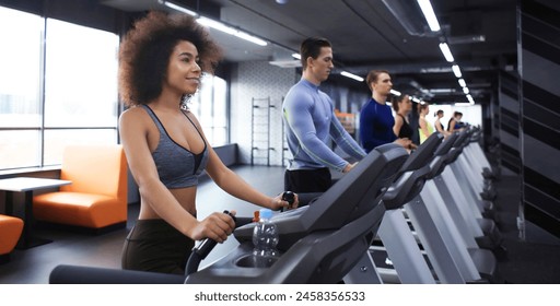 Group of people training on treadmills in gym - Powered by Shutterstock