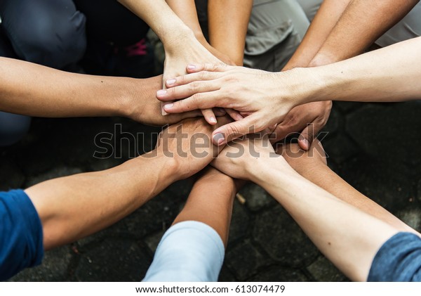 Group of people United Hands to built\
teamwork together with Spirit - teamwork\
concepts.