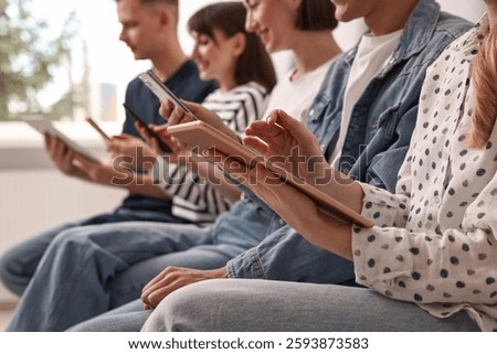 Group of people using different gadgets indoors, closeup. Modern technology