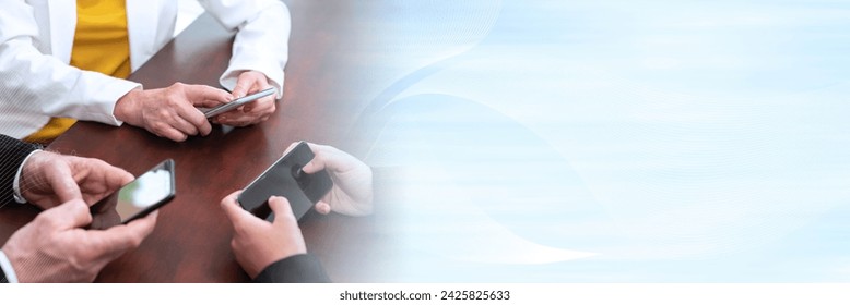Group of people using and looking at mobile phone together; panoramic banner
