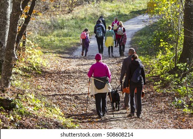 Group Of People Walking By Hiking Trail