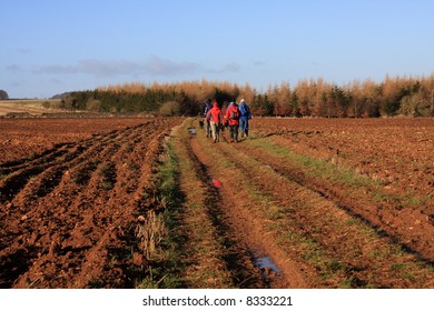 A Group Of People Walking In The Cotswolds