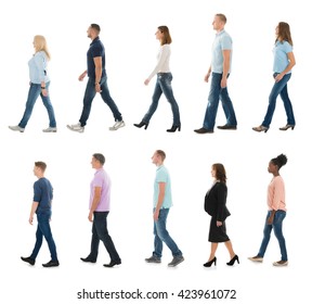 Group Of People Walking In Line Against White Background