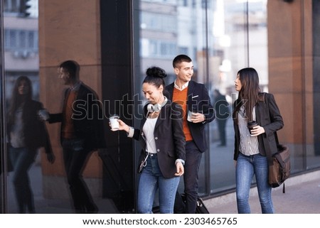 Group of people walking on a street with confidence. Businessmen and businesswomen traveling together.