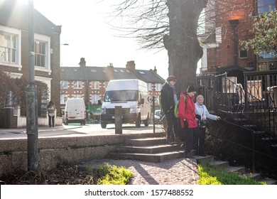 A Group Of People Walking Riverside Near White Hart Lane In Barnes London November 2019