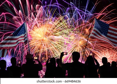 Group Of People Watching Fireworks On 4th Of July And Using Cellphones