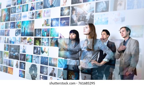 Group Of People Watching At A Lot Of Pictures. Internet Of Things. Information Communication Technology.