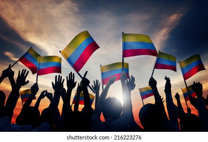 Group Of People Waving Colombian Flags In Back Lit