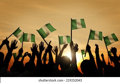 Group of People Waving Flag of Nigeria in Back Lit