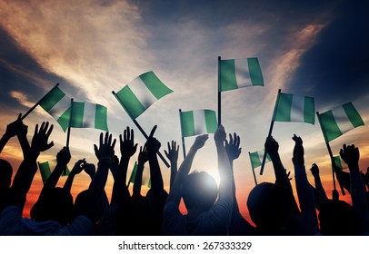 Group Of People Waving Flag Of Nigeria In Back Lit