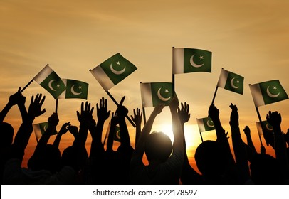 Group Of People Waving Flag Of Pakistan In Back Lit