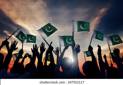 Group Of People Waving Flag Of Pakistan In Back Lit