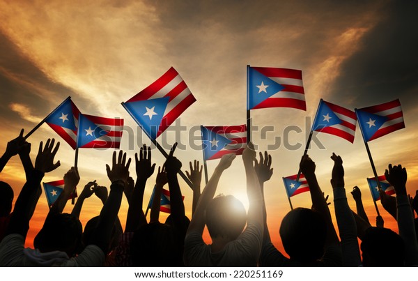 Group of\
People Waving Flag of Puerto Rico in Back\
Lit